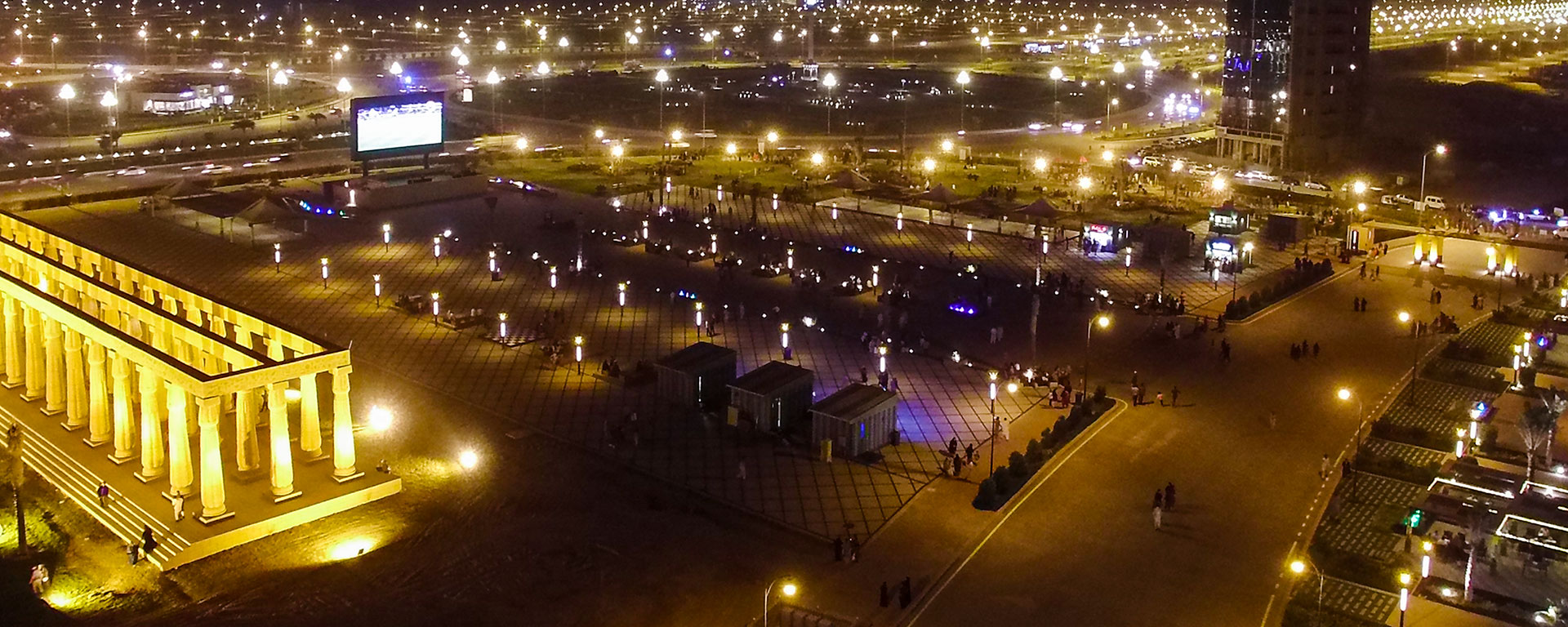 Bahria Town Lahore boulevard lit up at night